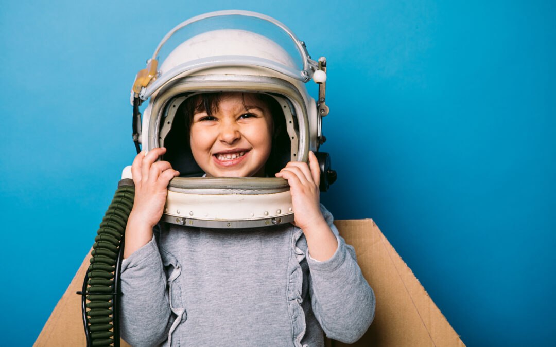 Young girl with astronaut helmet smiling at camera denoting career readiness and STEM education