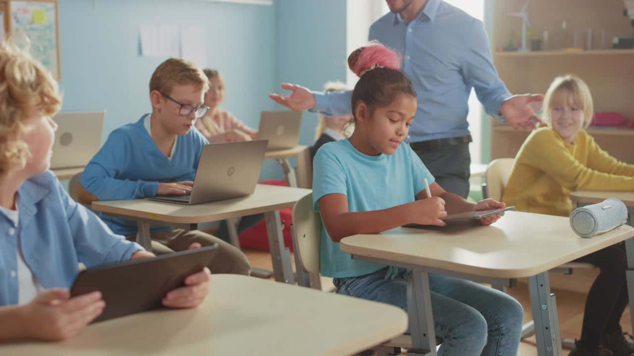 boys taking online coding program from learning.com on tablets at middle school